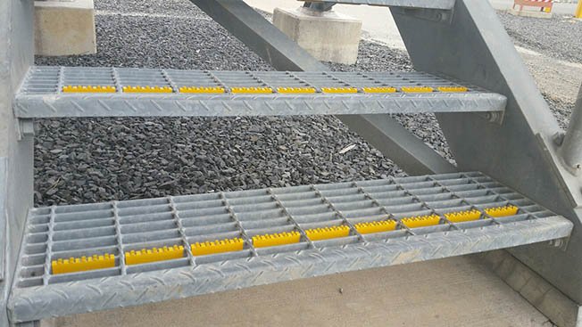 AMCO U-Tred anti-slip stair nosings are used on steel grate steps for improved safety.