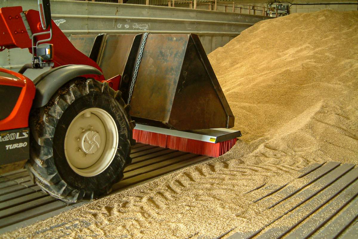 AMCO Sweepex Broom in use in a grainshed