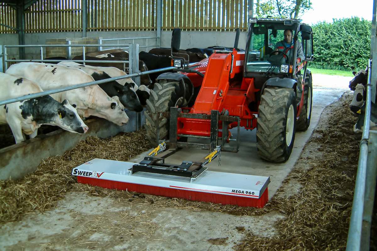 AMCO Sweepex Broom in use in a cowshed