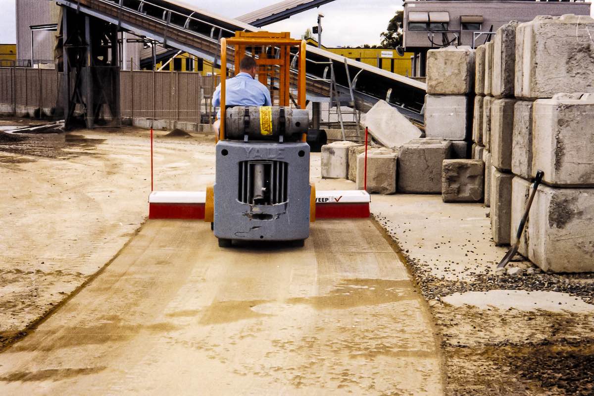 AMCO Sweepex Broom in use in a manufacturing facility
